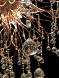 Top design detail of firework-inspired gold crystal chandelier.