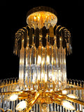 Close-up view of luxury gold crystal chandelier showcasing radiant tiered crystal prisms.