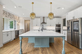 Polished gold chandelier illuminating kitchen island area