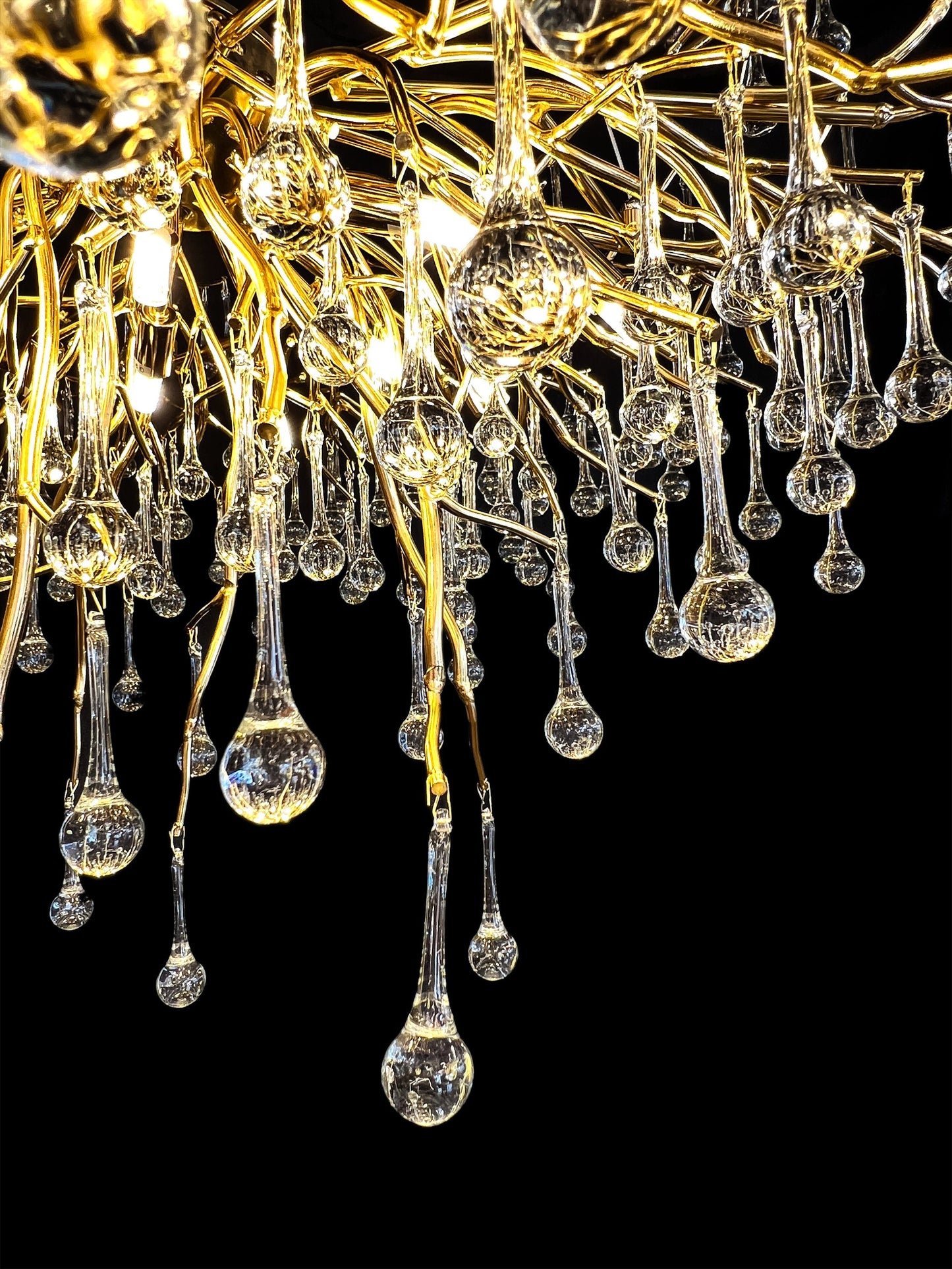 Bottom view of gold branch chandelier with hanging glass drops