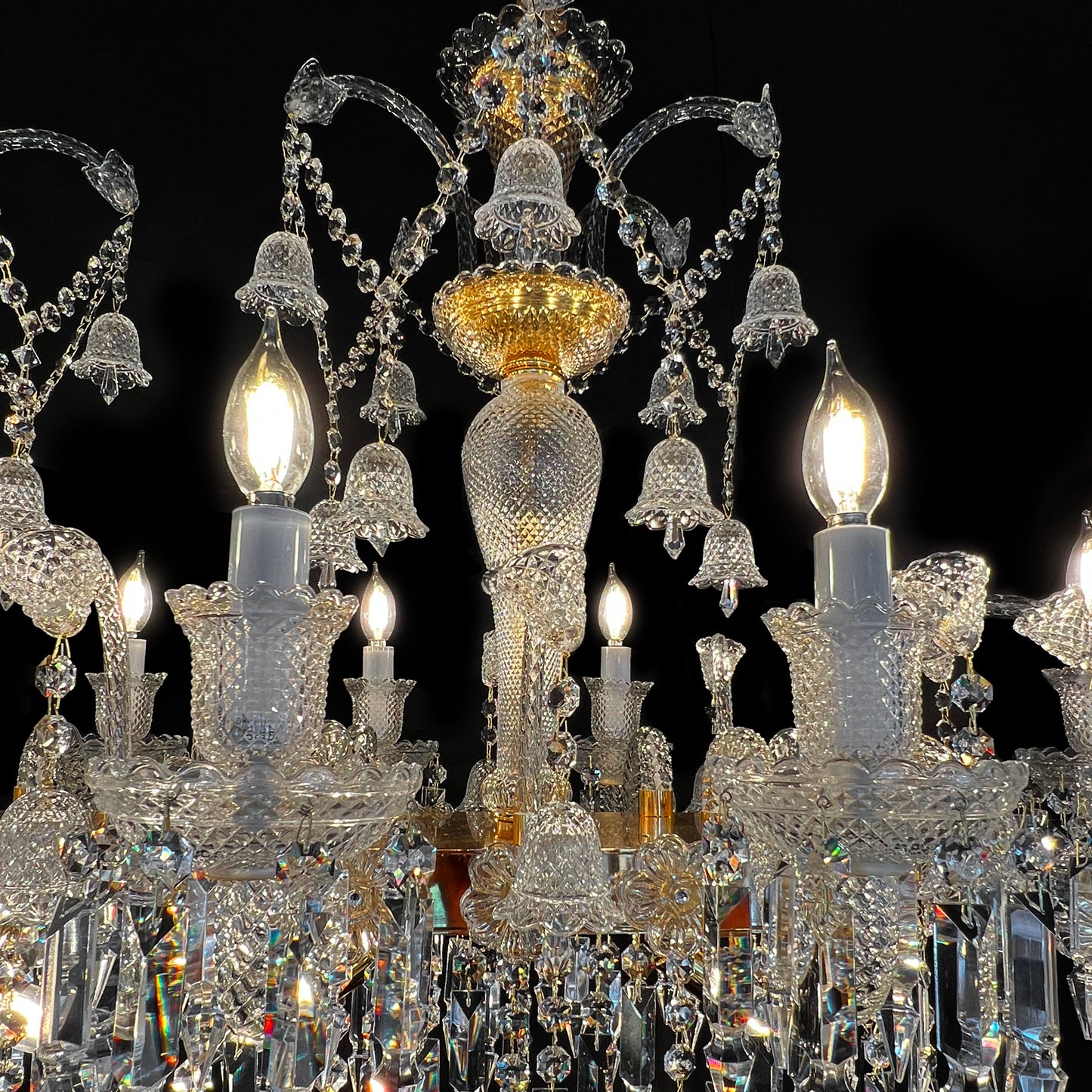 Close-up of handcrafted glass arm and crystal holder showcasing fine glass texture and precision-cut crystal brilliance.

