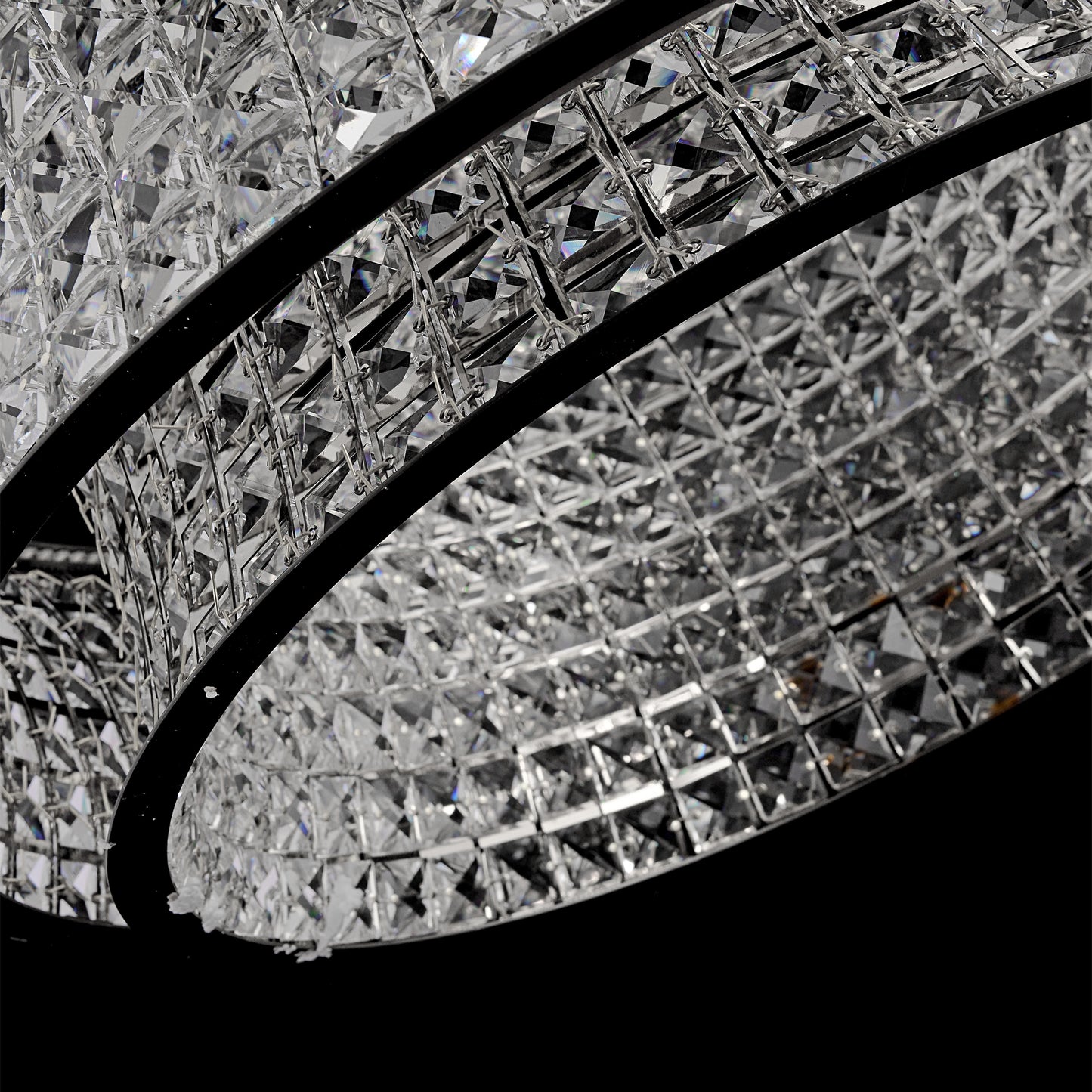 Minimal modern view of suspended round crystal LED chandelier with chrome canopy.