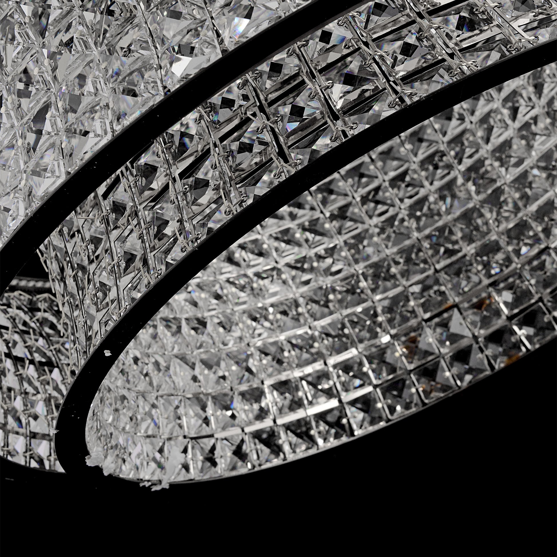 Minimal modern view of suspended round crystal LED chandelier with chrome canopy.