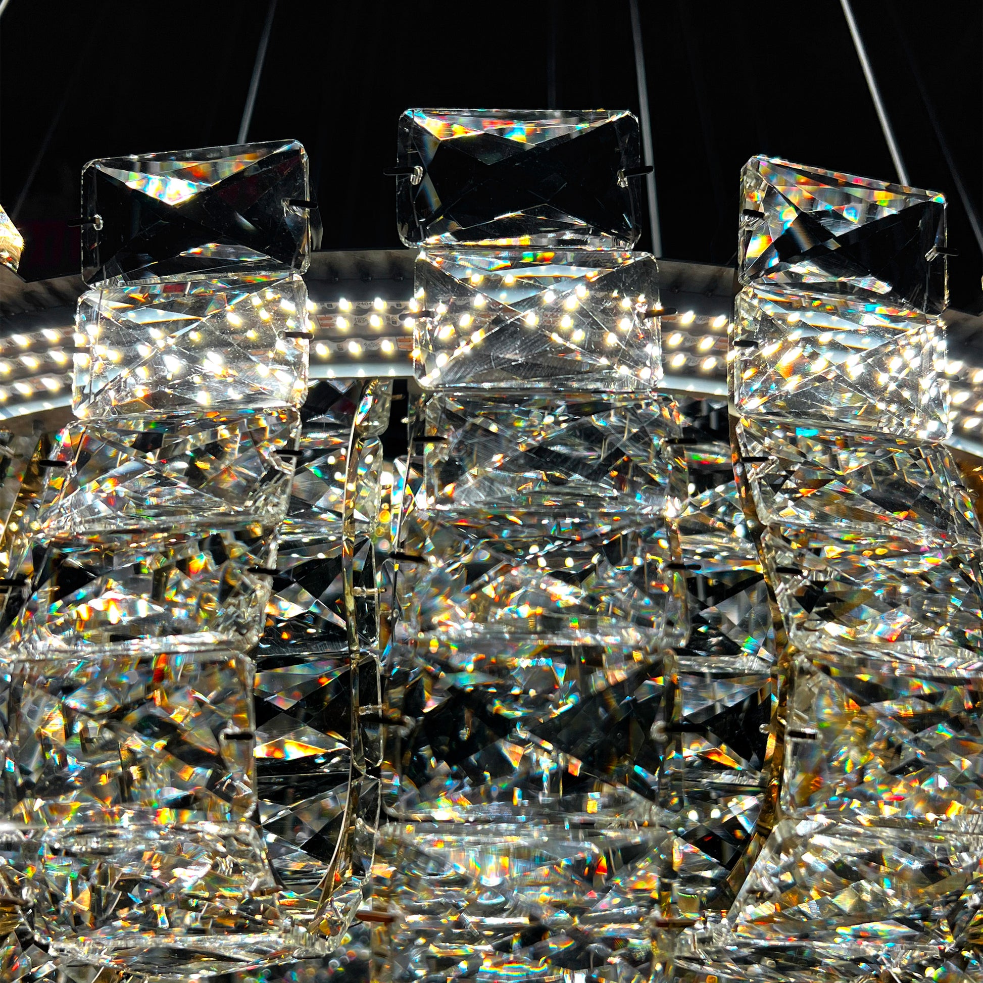 Close up of premium K9 crystal blocks on luxury gold chandelier, highlighting clarity and reflective sparkle.
