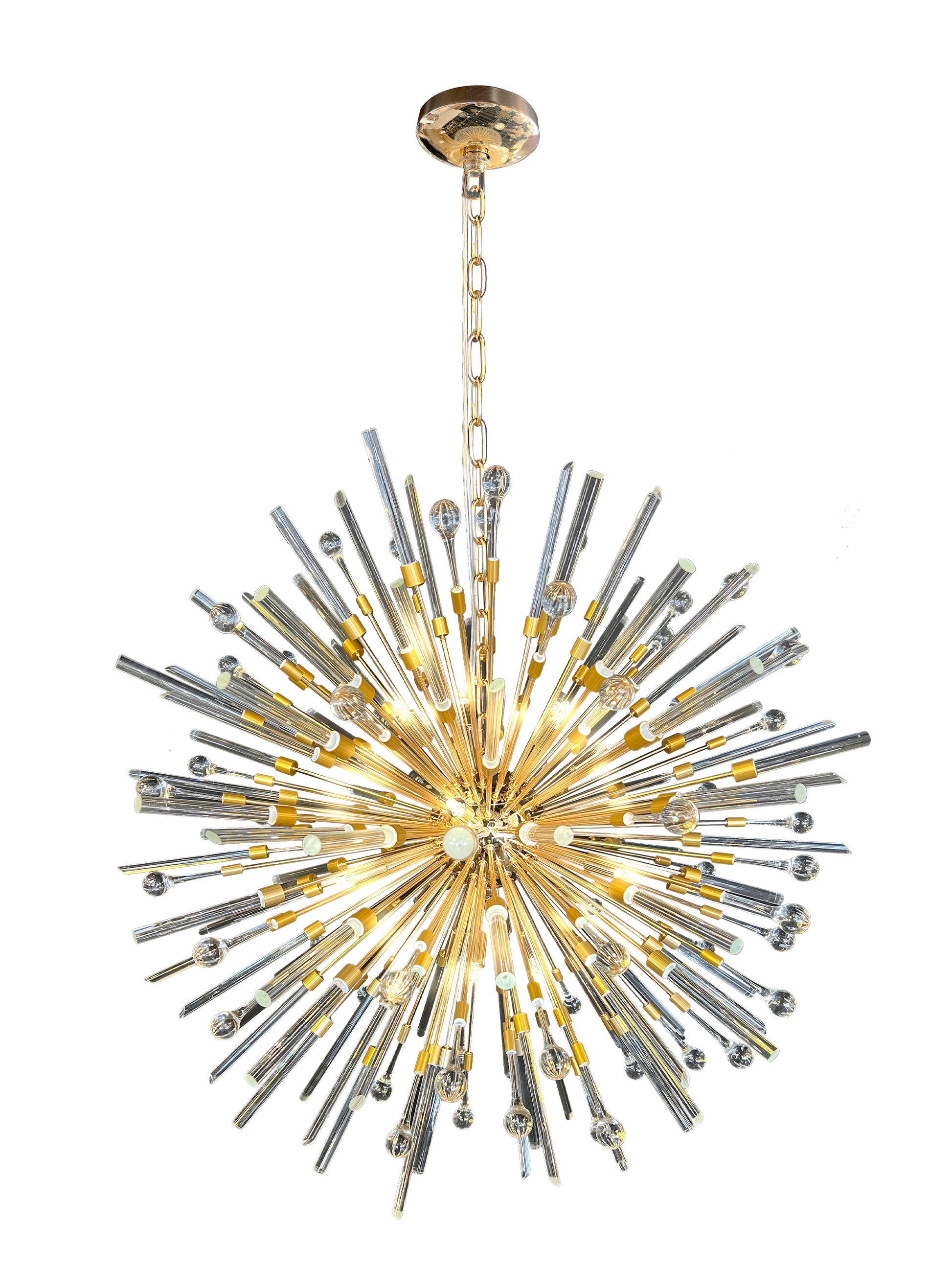 Side view of luxury gold pendant chandelier showcasing warm lighting.