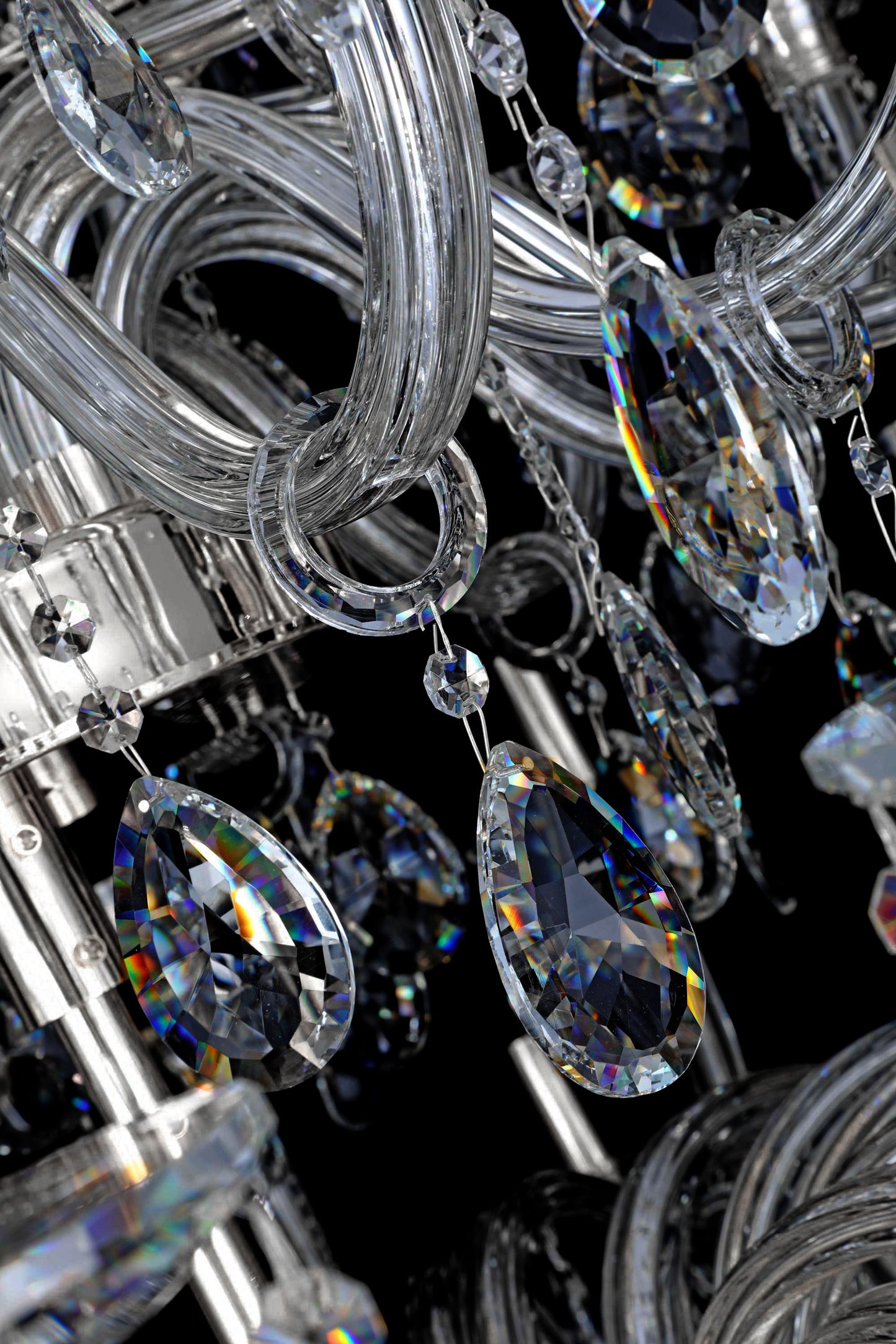 Close-up of chrome crystal chandelier featuring tiered crystal strands and reflective brilliance.