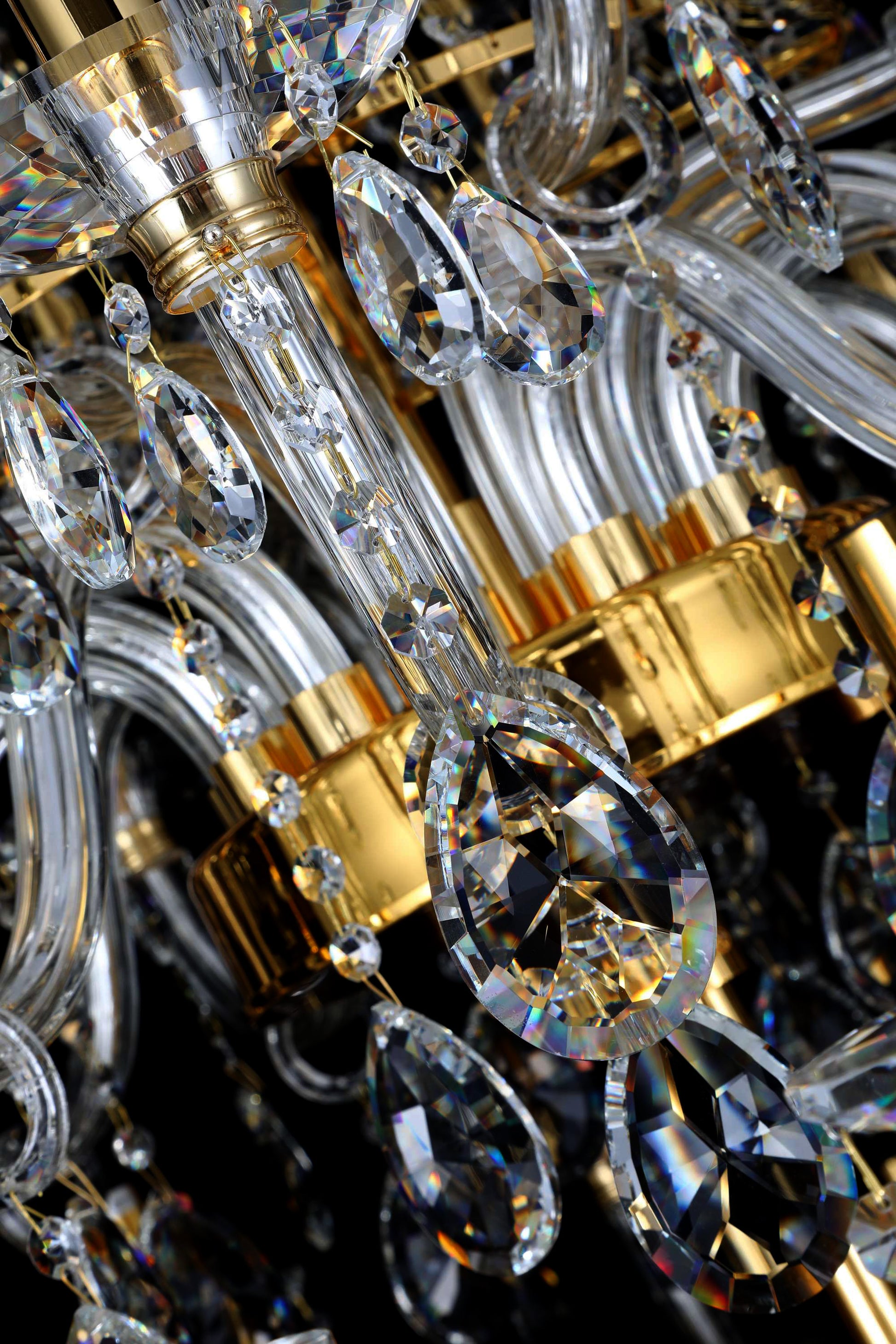 Luxury gold chandelier detail showing candelabra-style light holders and crystal brilliance.