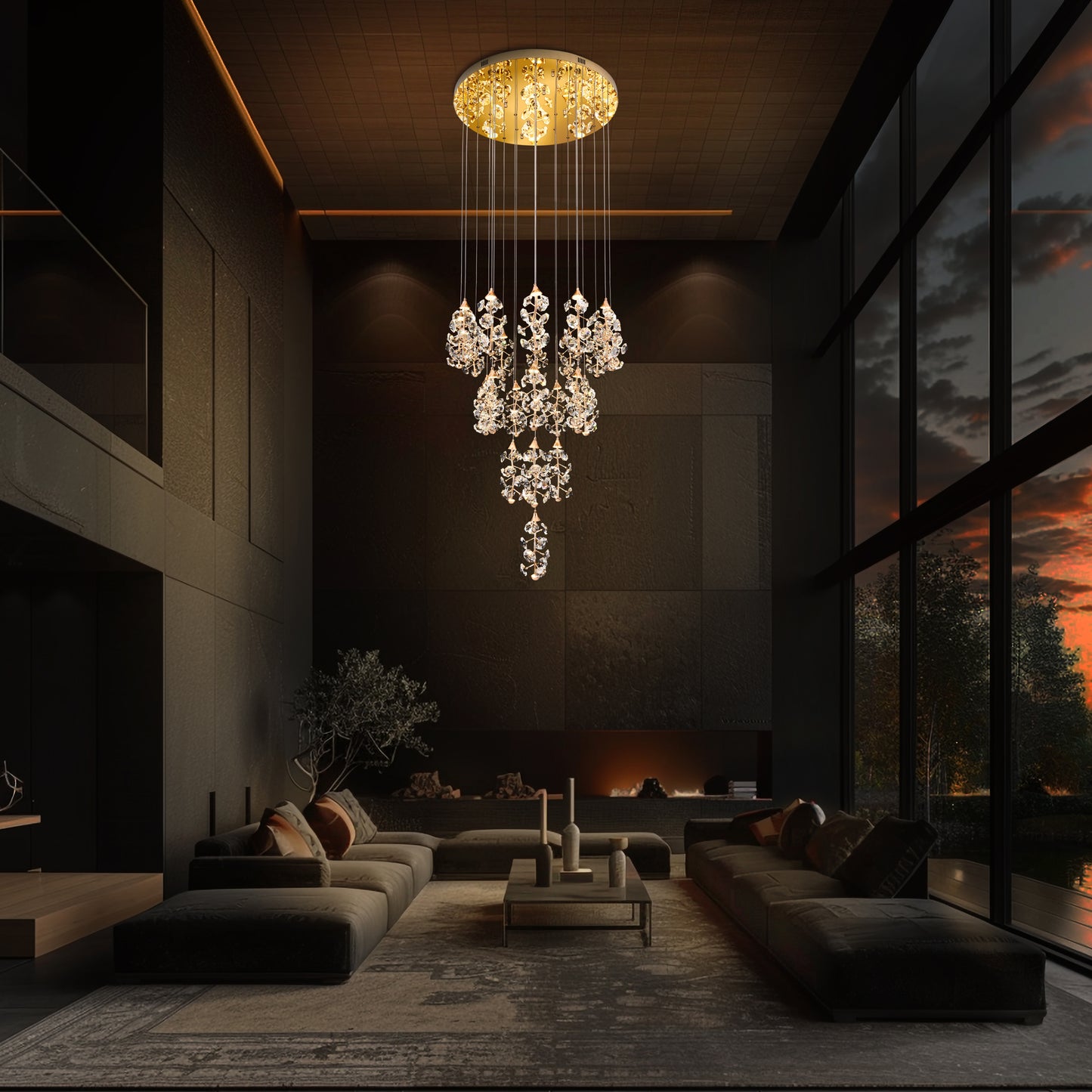 A gold-finished modern crystal chandelier with multiple cascading drops, hanging in a well-lit room with floor-to-ceiling windows.
