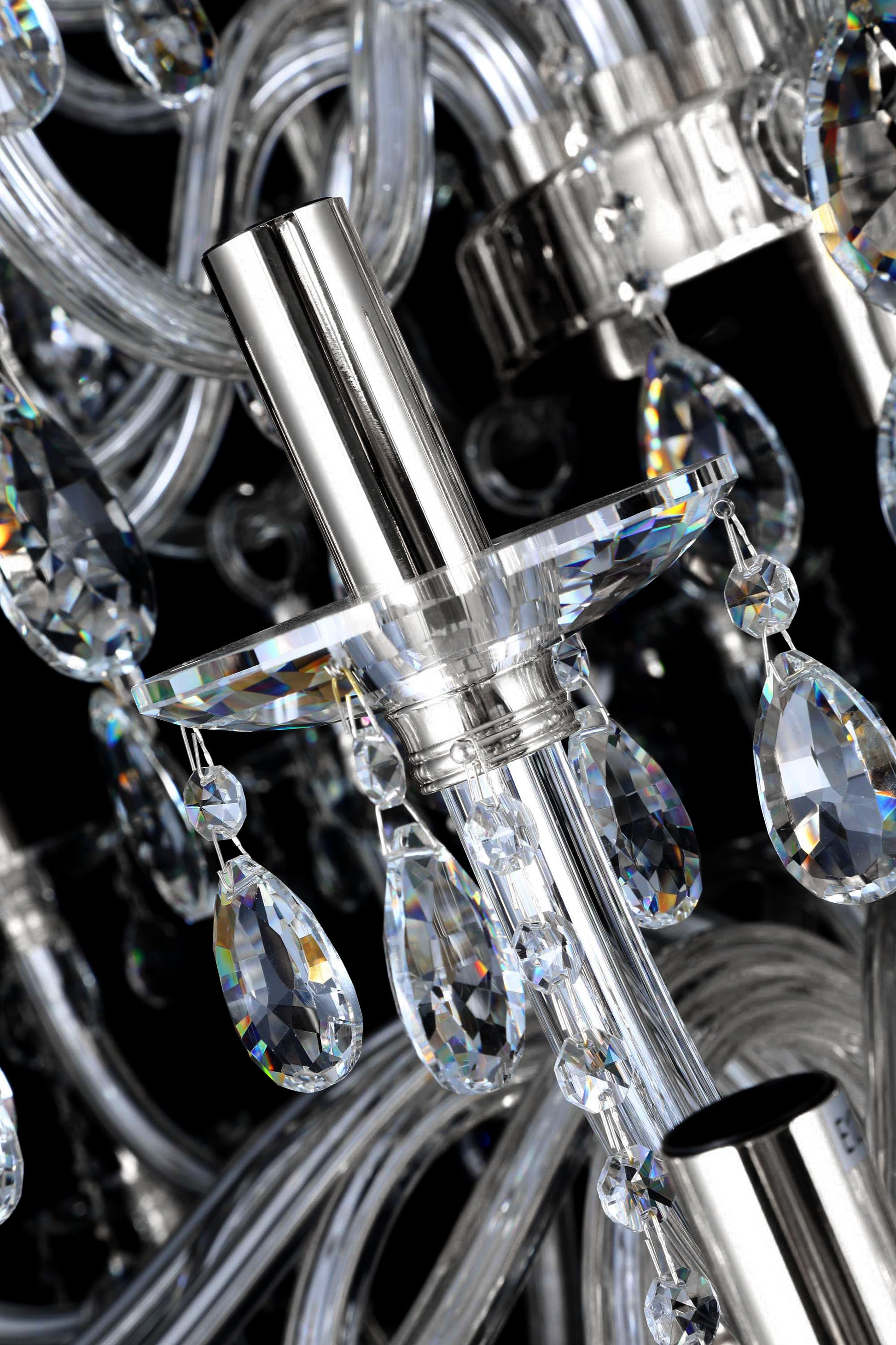 Modern chrome chandelier light holder with intricate crystal drops and reflective metallic finish.