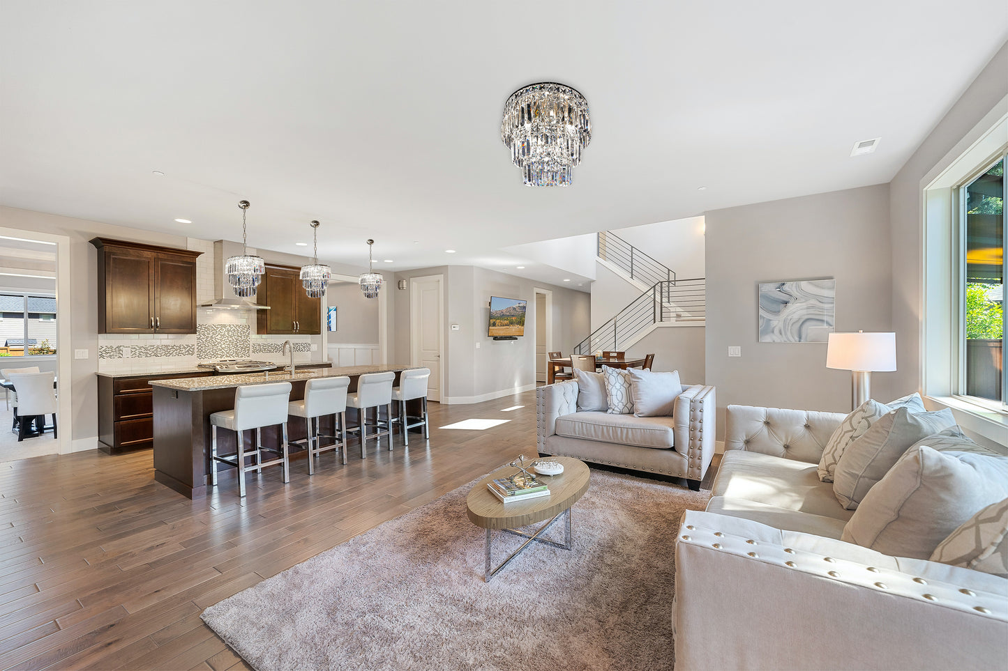 Tiered crystal chandelier lighting in open modern living space