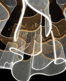 : Close-up of gold acrylic LED chandelier with soft illuminated curves