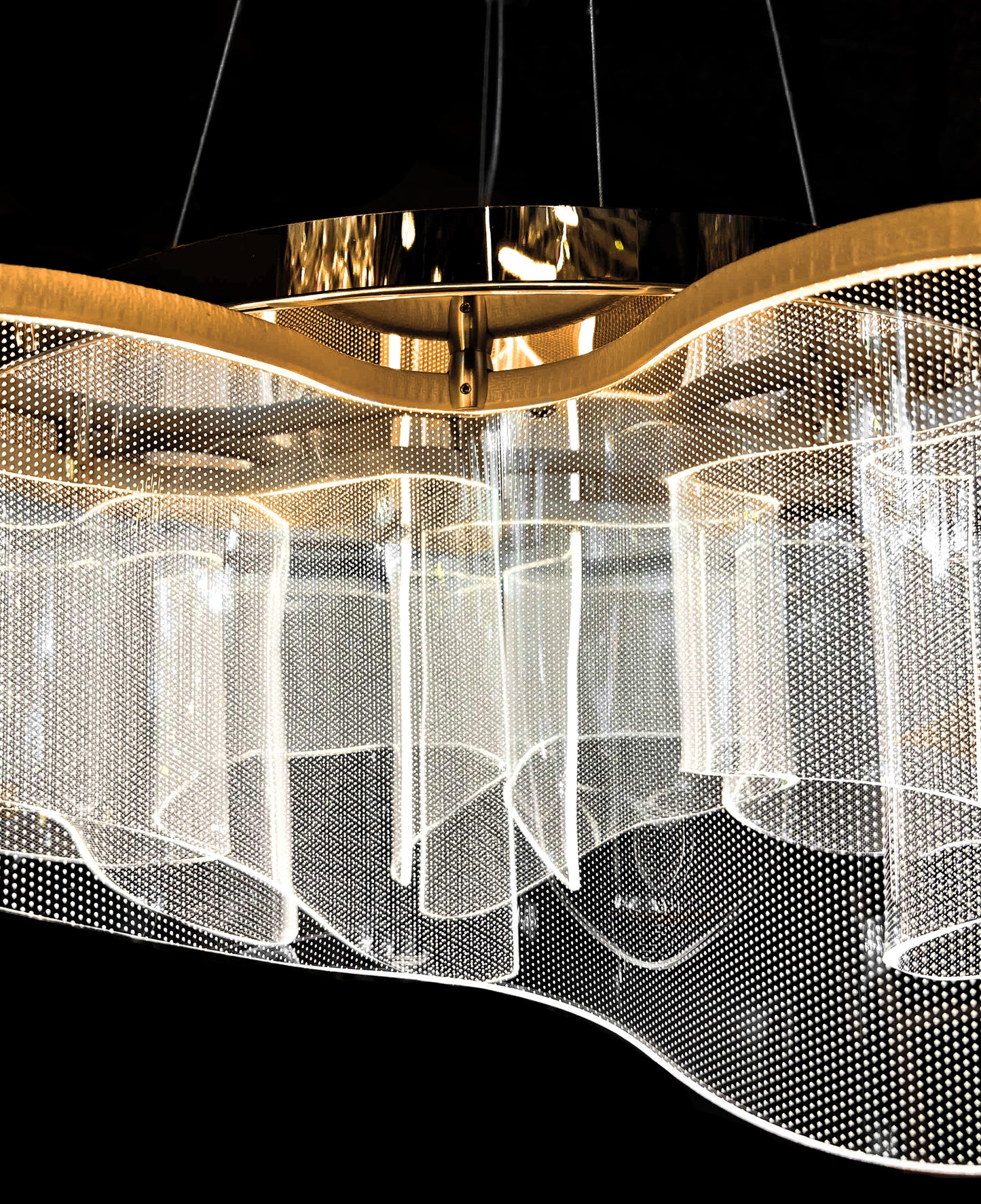 Overhead view of gold LED chandelier with artistic wave design