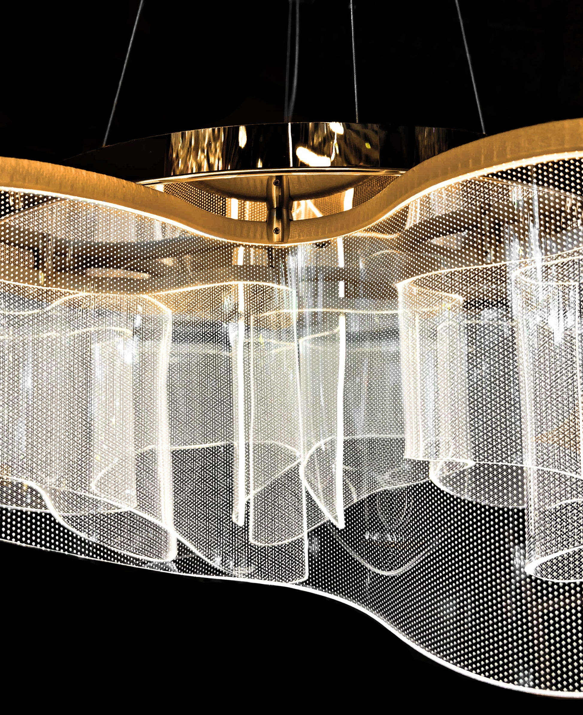 Overhead view of gold LED chandelier with artistic wave design