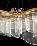 Overhead view of gold LED chandelier with artistic wave design