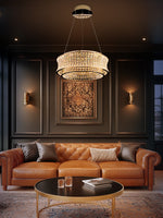 gold dimmable crystal LED chandelier illuminating a contemporary living room with sofa and coffee table.