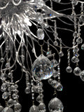 Circular crystal halo chandelier with layered crystal arrangement.
