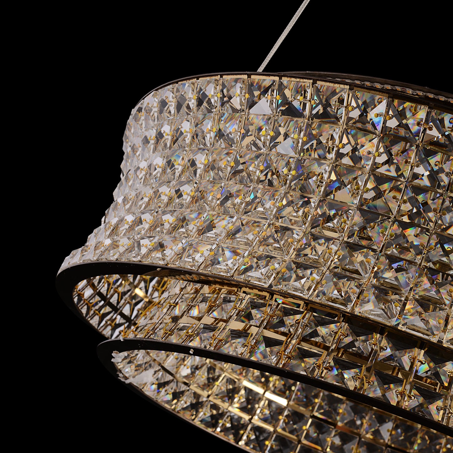Side angle view of gold crystal LED chandelier with suspended double-ring crystal layers.