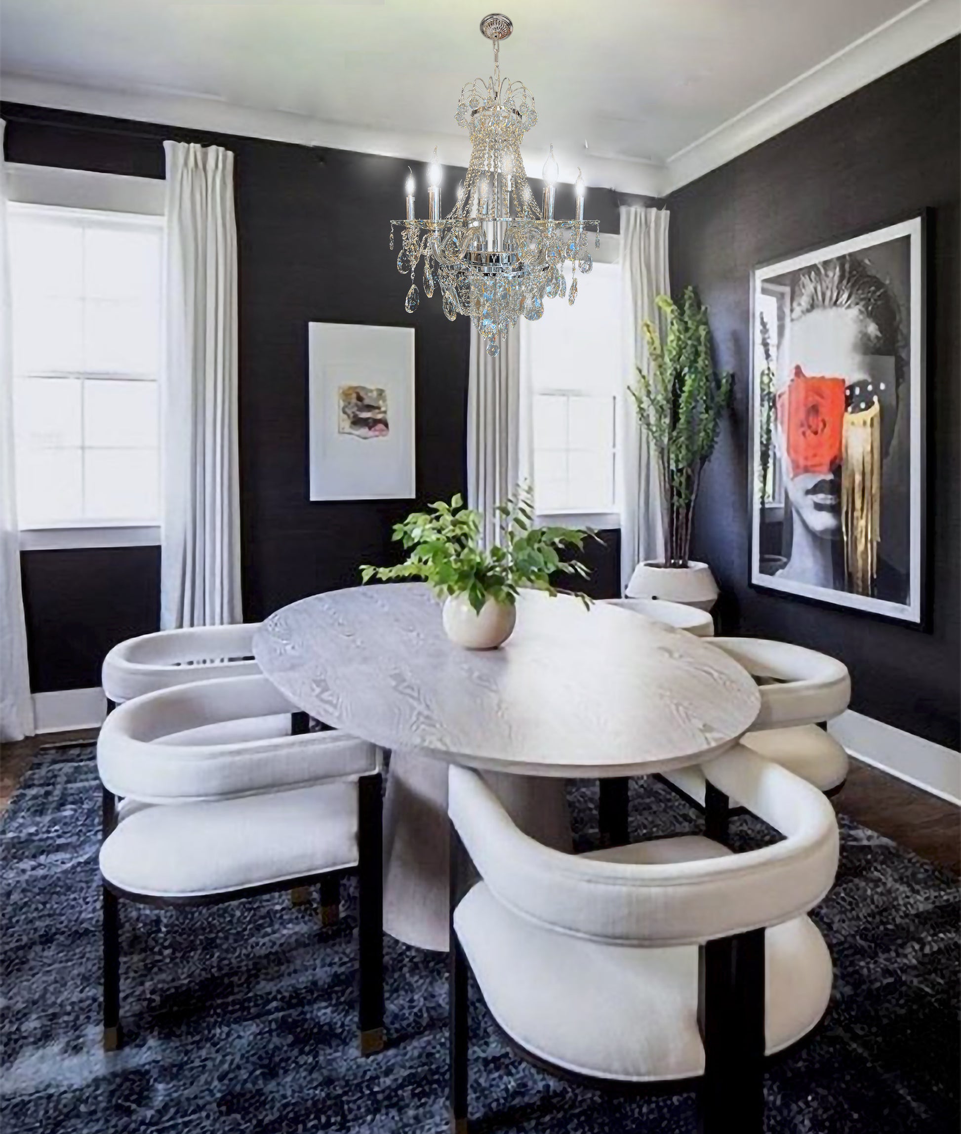 Elegant chrome  crystal chandelier above classic dining table with modern wall paneling.