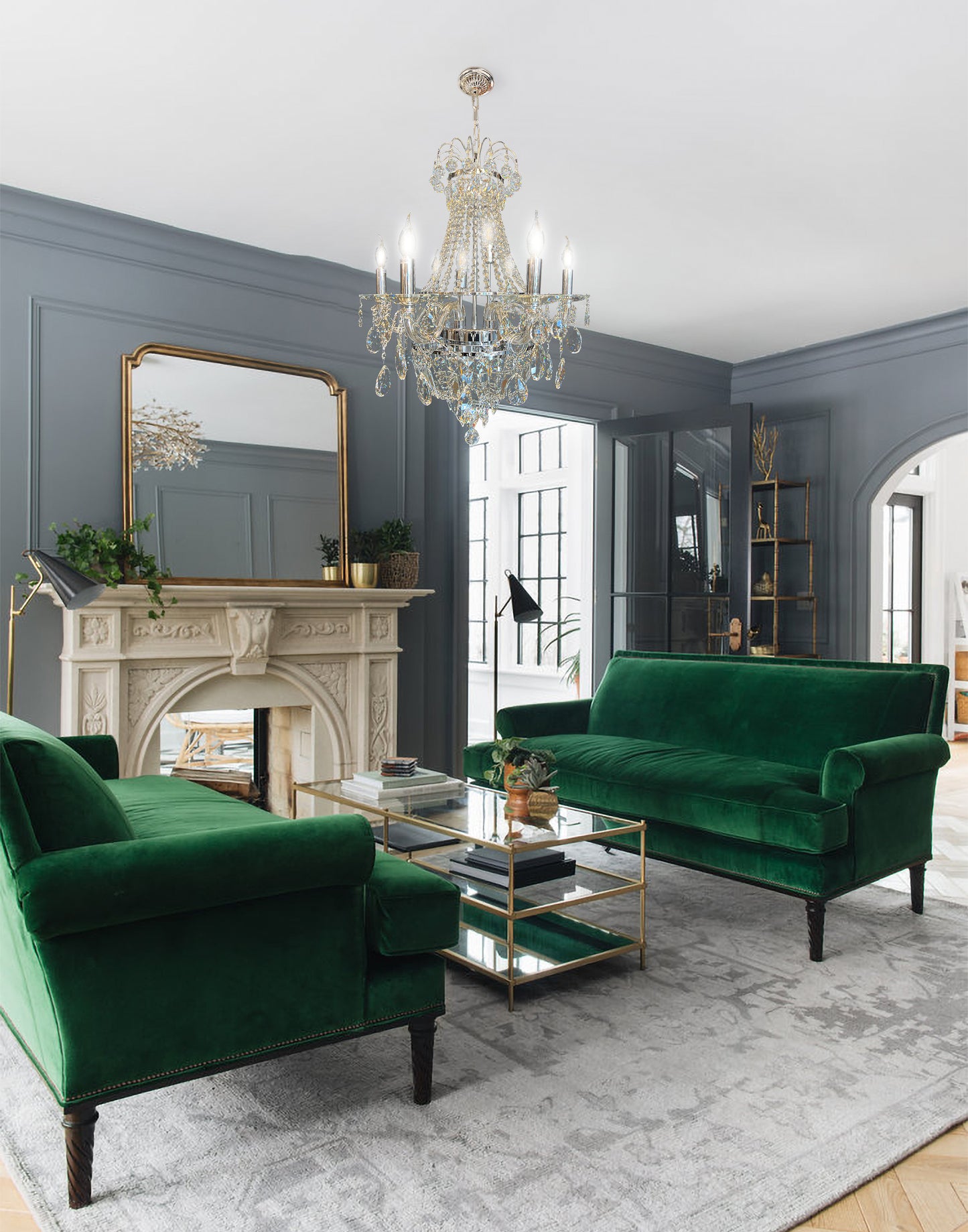 polished chrome  crystal chandelier illuminating classic living room interior with green sofa.