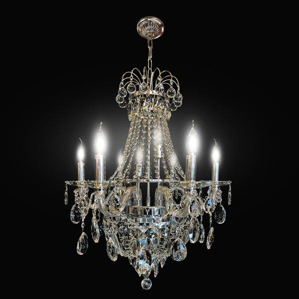 A luxurious vintage crystal chandelier with a chrome finish, featuring many precision-cut crystals and eight light bulbs, designed to provide brilliance and sparkle.