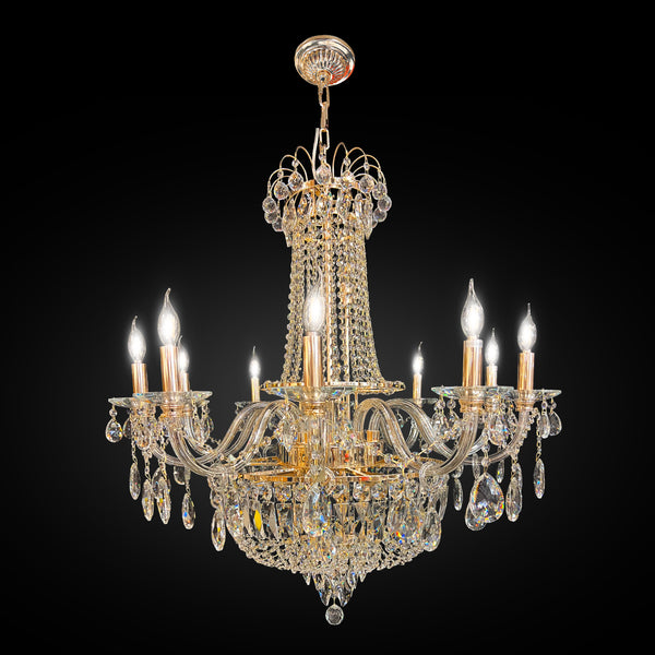 A Barroco style gold finish crystal chandelier with intricate detailing and multiple light bulbs.