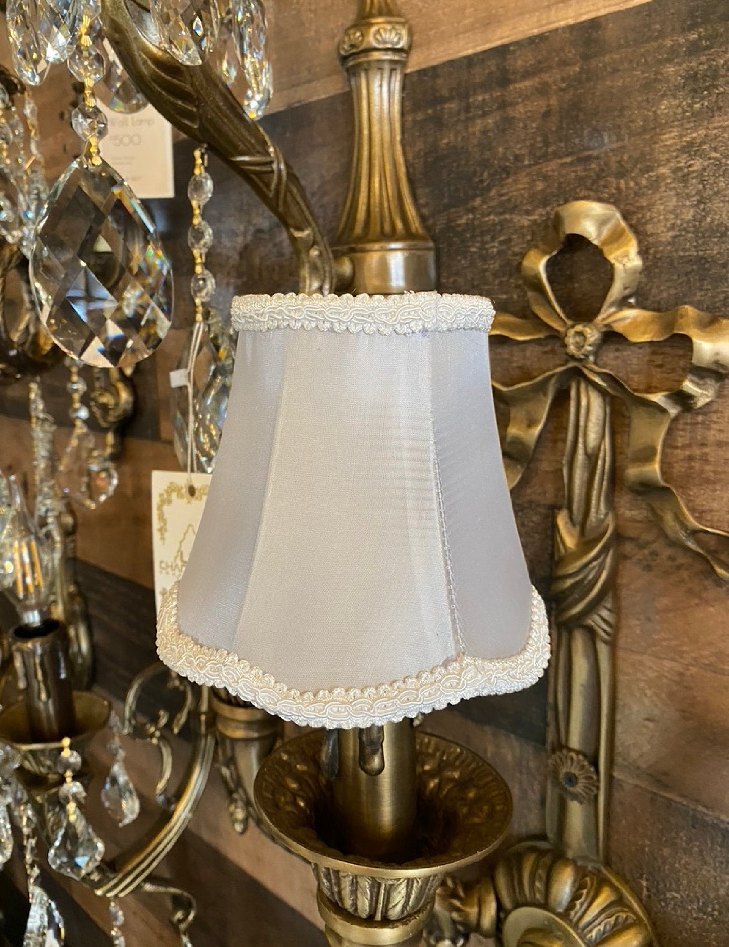 Gray satin fabric lamp shade styled on wall sconce
