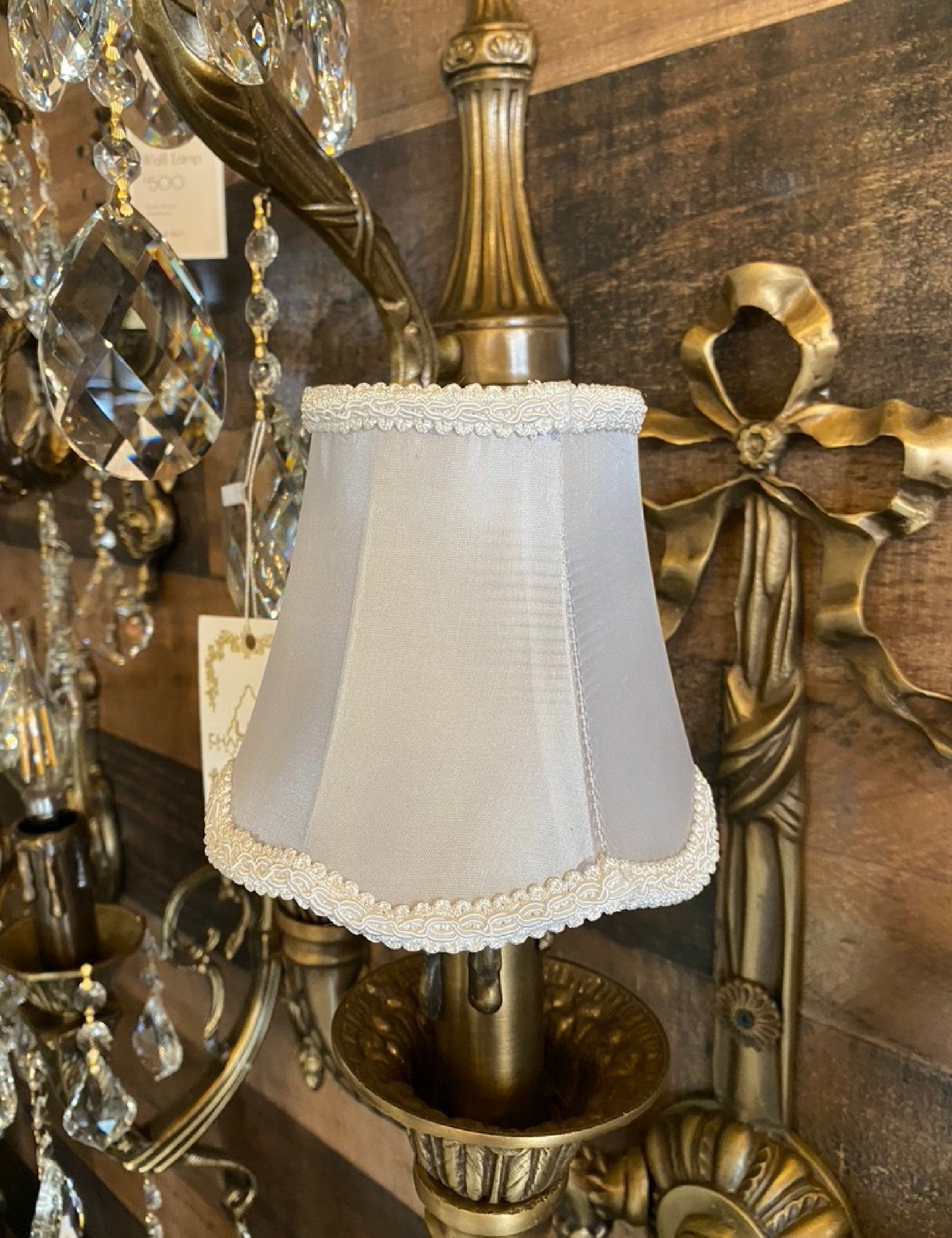 Gray satin fabric lamp shade styled on wall sconce
