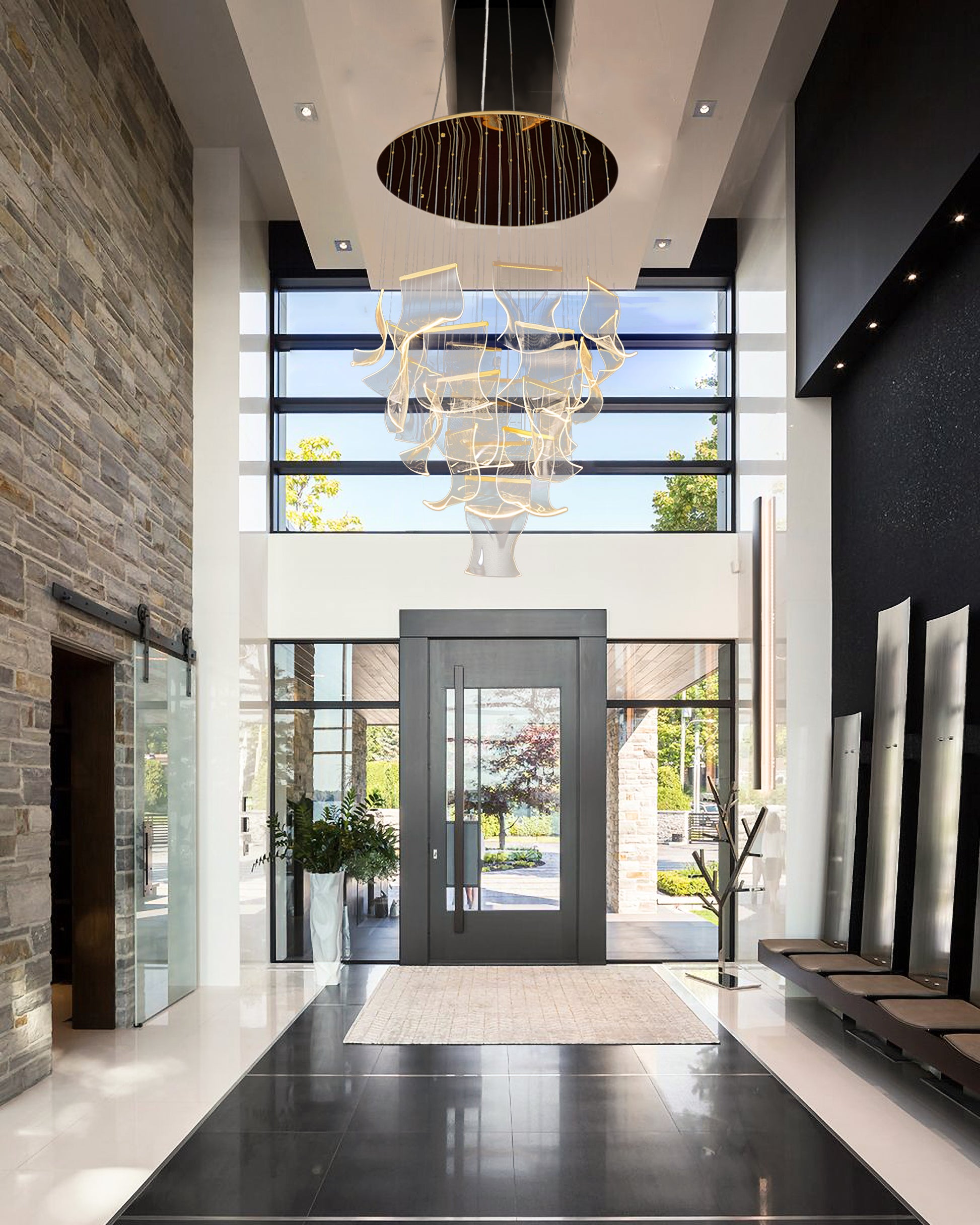 Dimmable and adjustable  gold LED chandelier with sculpted wave panels enhancing a luxurious modern entryway.

