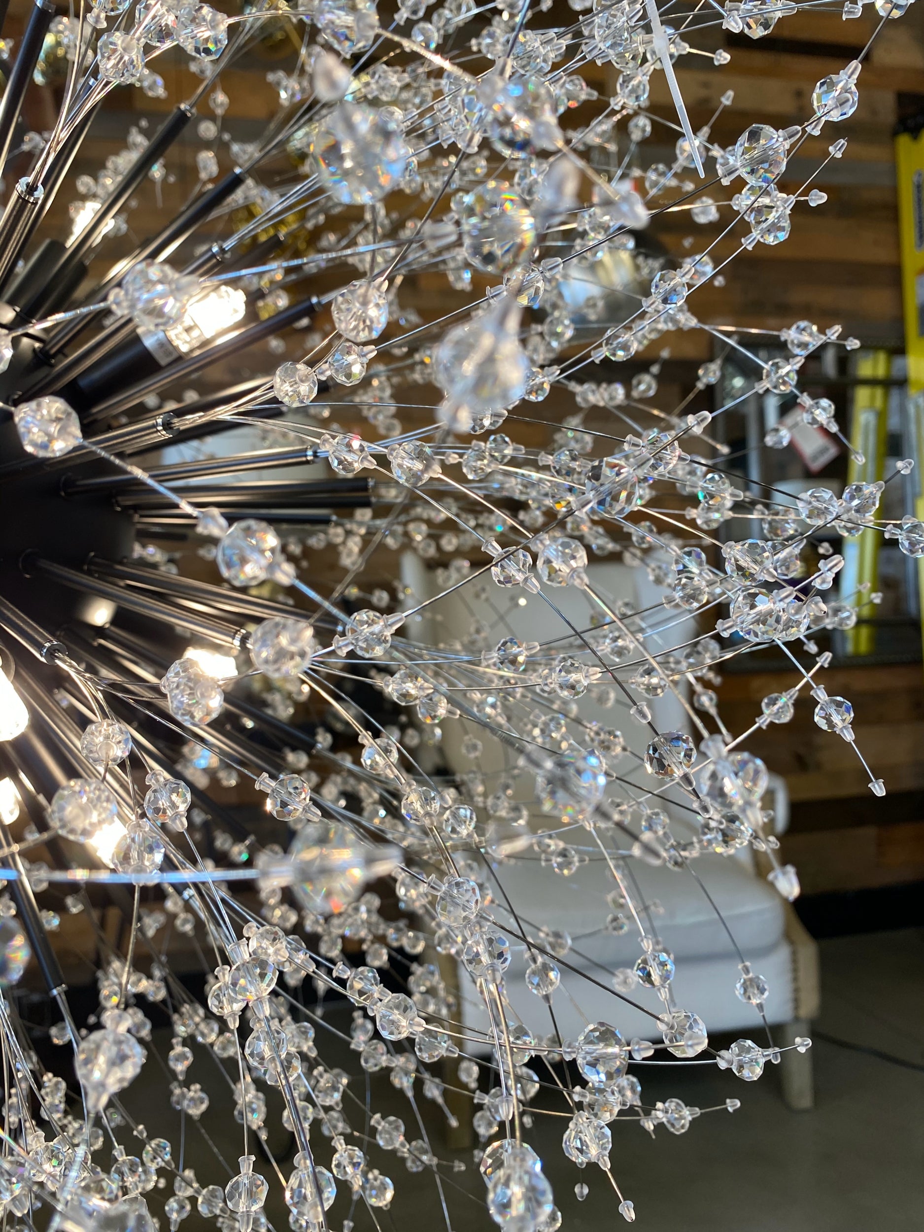 Precision-cut crystal branches detail on modern black chandelier