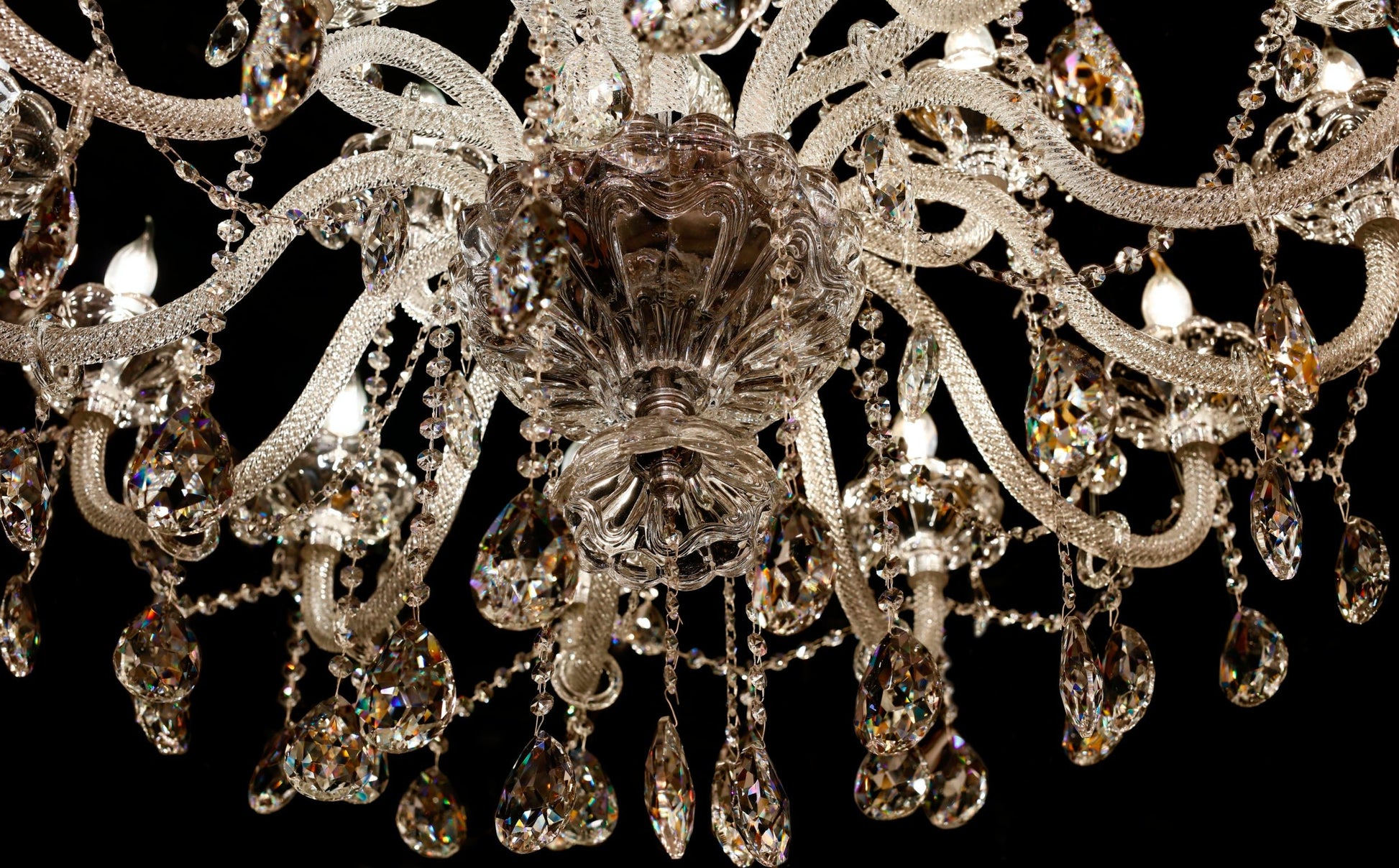 Detailed view of the chandelier’s chrome arm and crystal accents.
