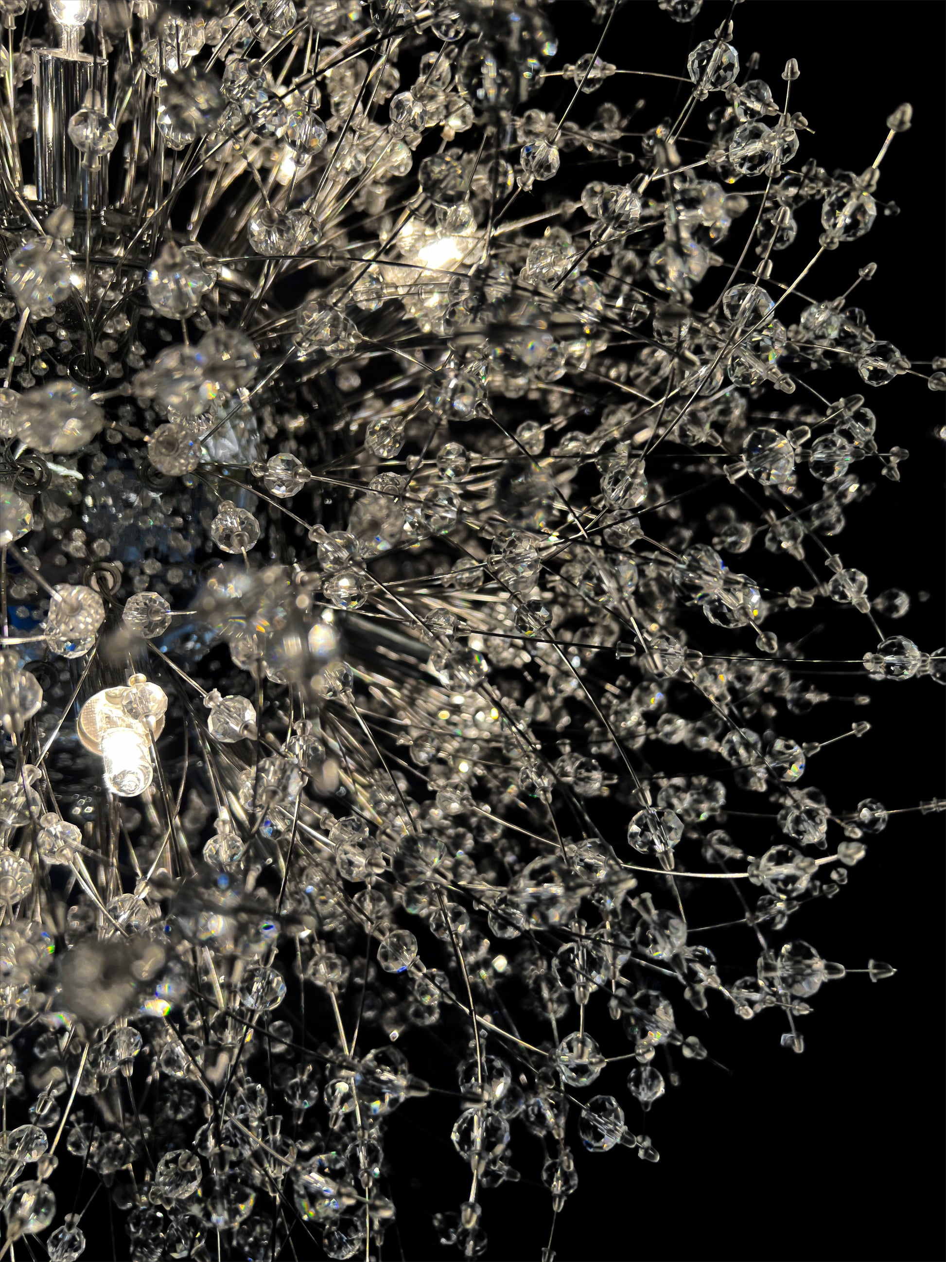  Detailed close-up of chrome starburst chandelier with sparkling crystals