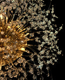 Close-up of crystal details on gold flush mount chandelier with dimmable lighting