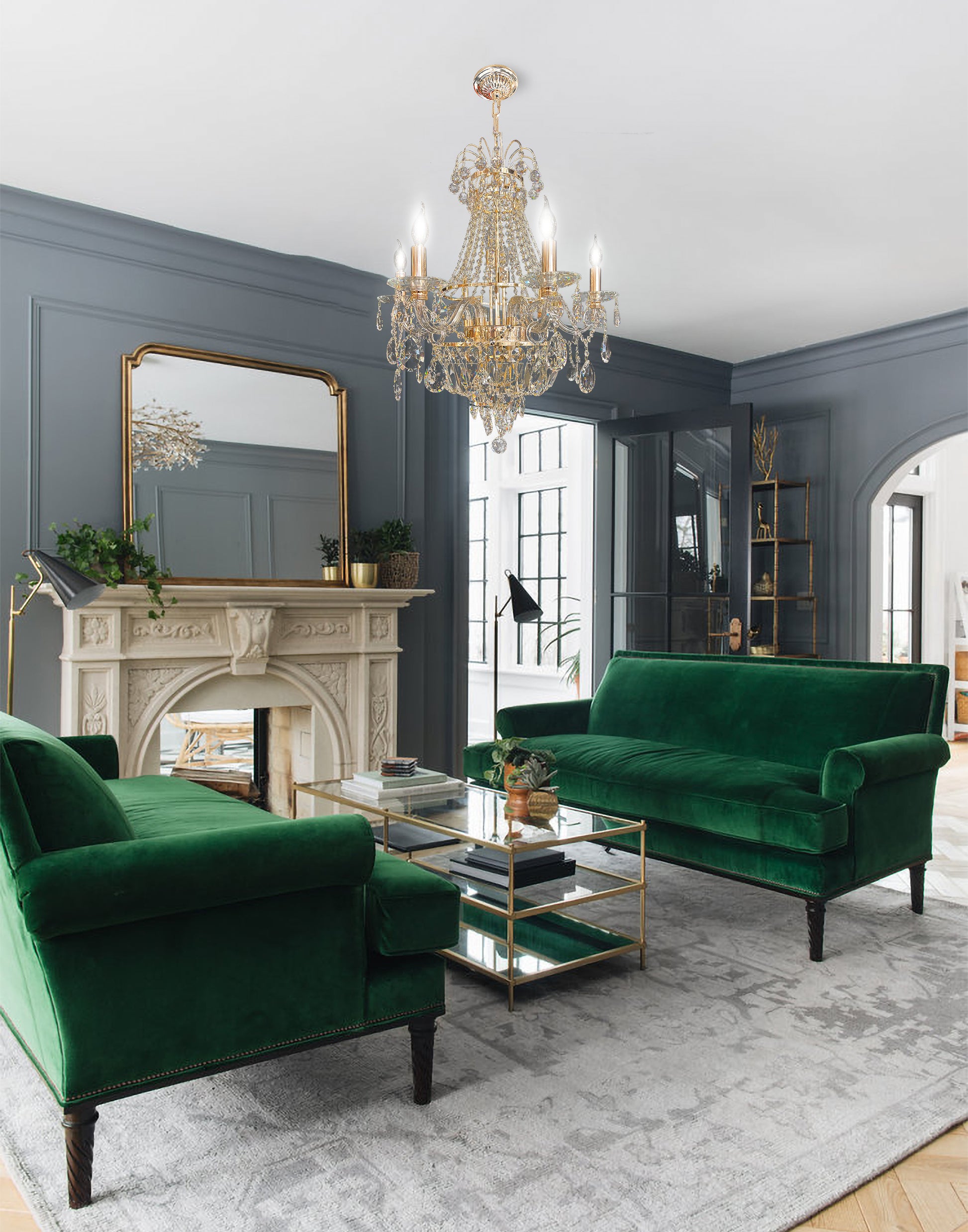 Gold crystal chandelier illuminating classic living room interior with green sofa.