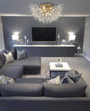 Elegant gold flush mount chandelier illuminating modern living room interior