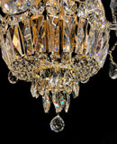 Detailed gold chandelier base with hanging crystals reflecting warm light