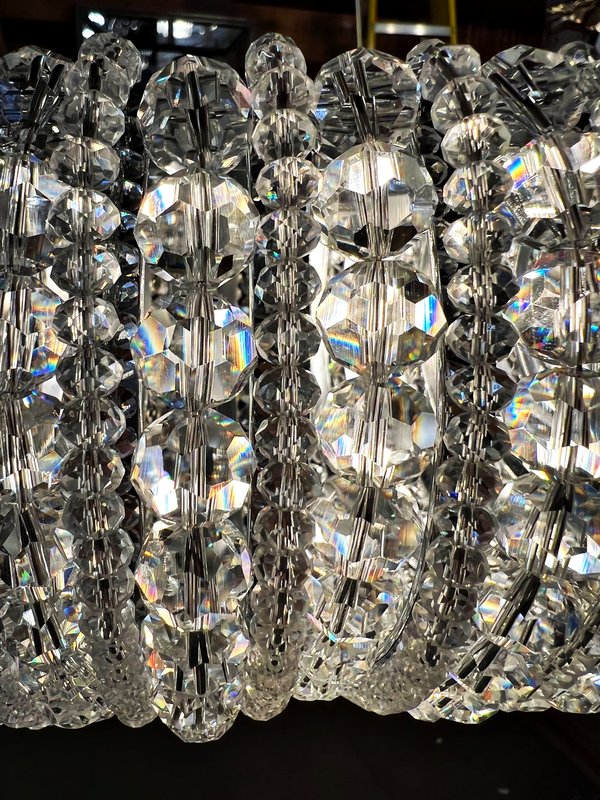 Chrome halo chandelier with layered crystals and polished circular frame