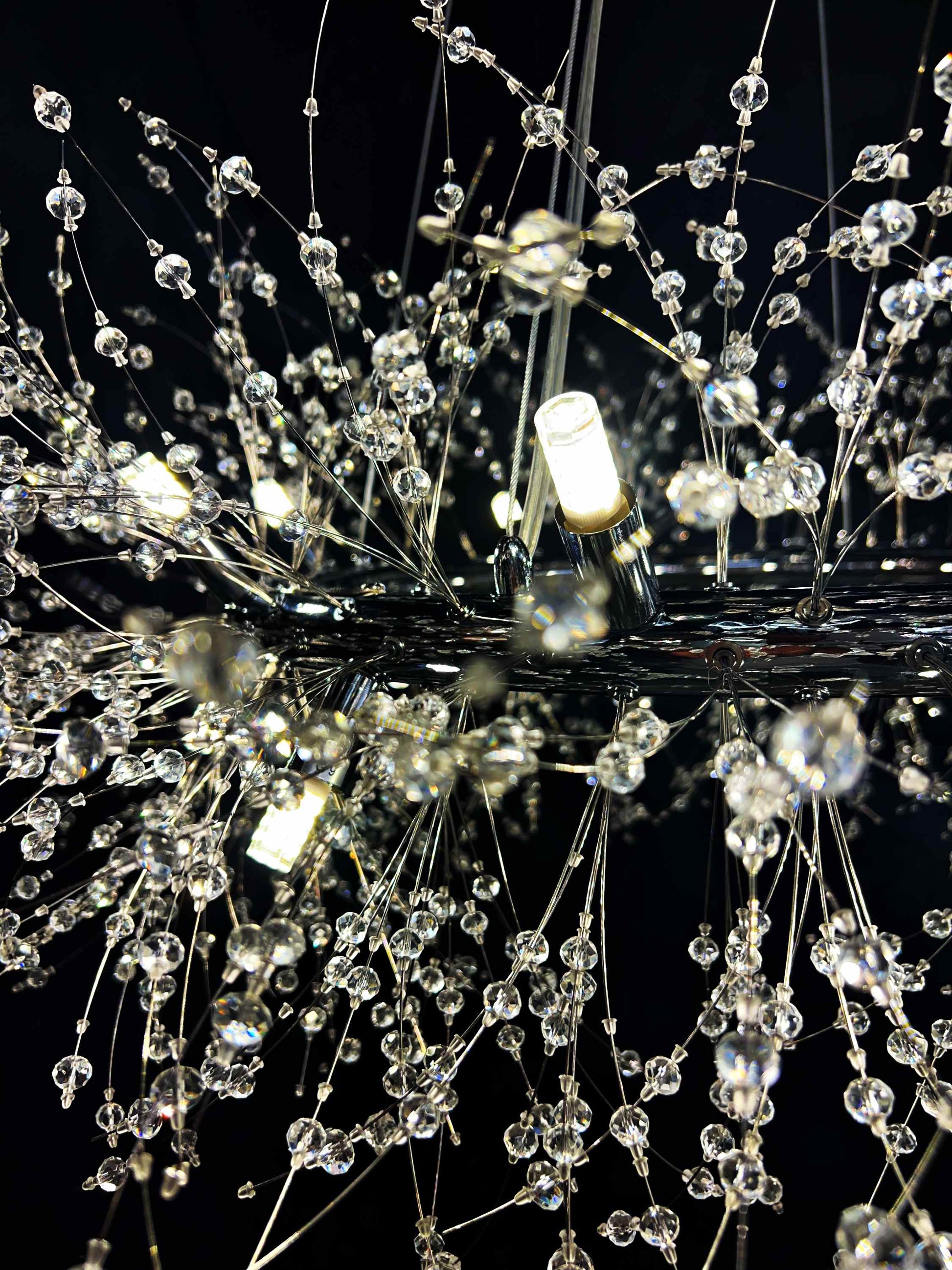 Detail view of G9 LED bulbs in chrome chandelier