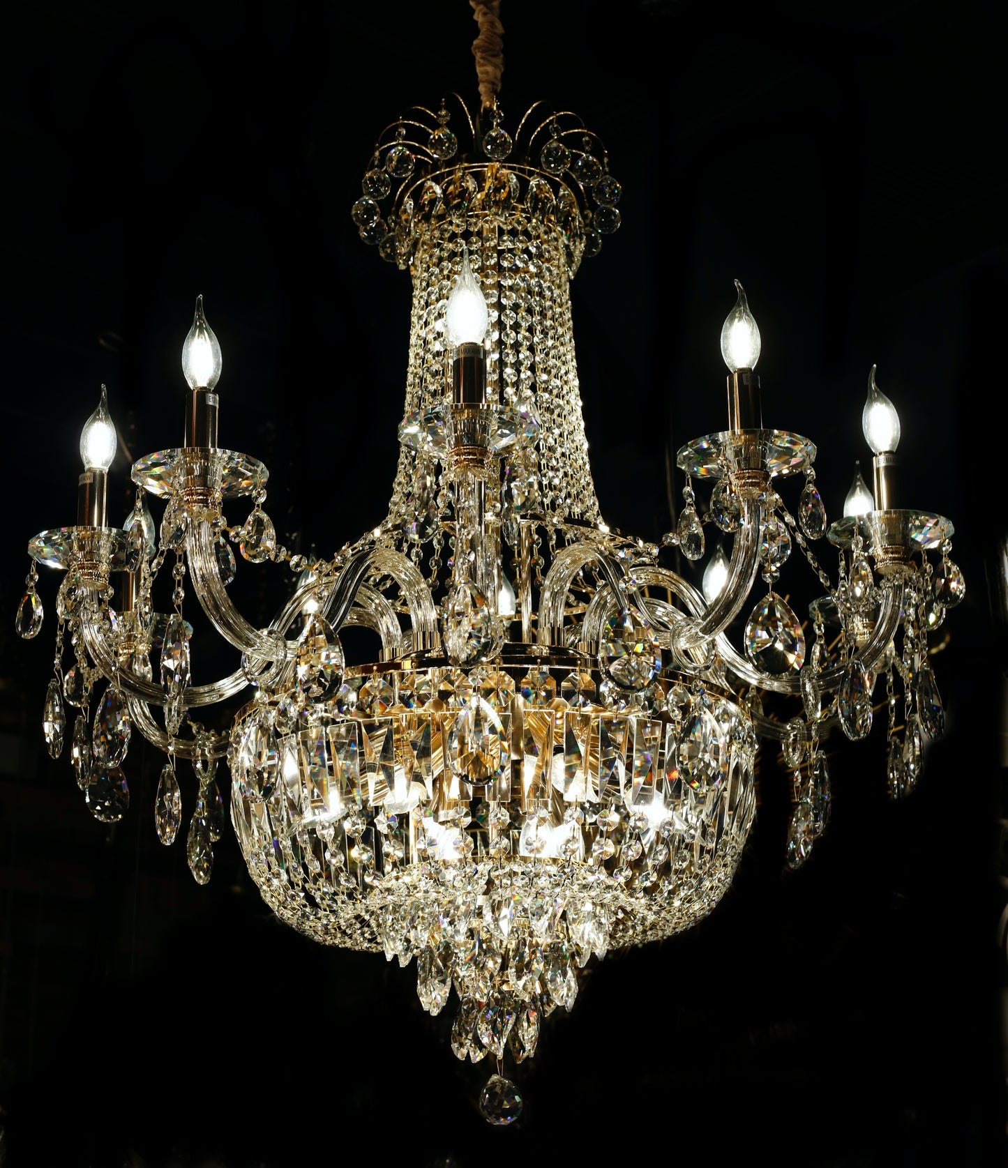 Luxury gold crystal chandelier with empire silhouette and candle-style lights.
