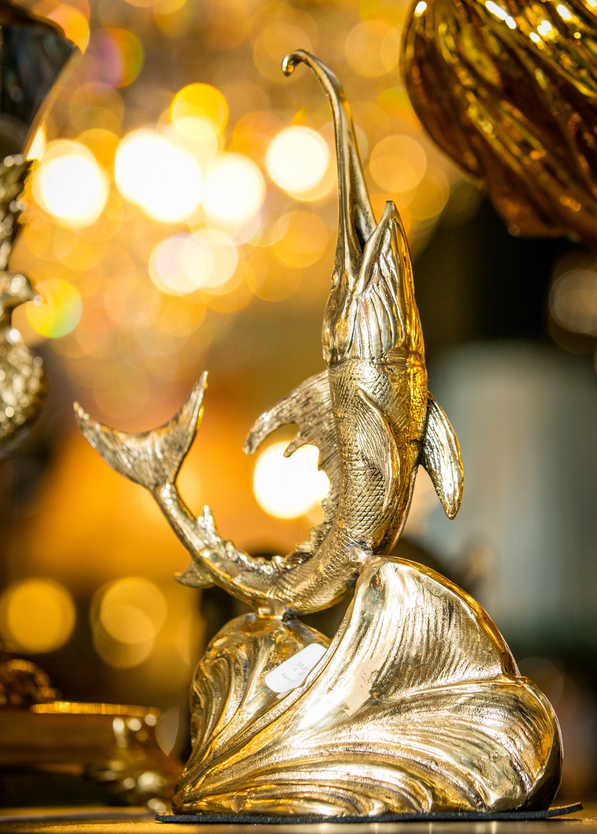 Detailed view of the solid brass swordfish statue displayed in a luxury nautical setting