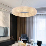 Elegant chrome halo chandelier suspended over dining area with soft lighting