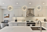 Luxury crystal chandelier over kitchen island with polished chrome finish