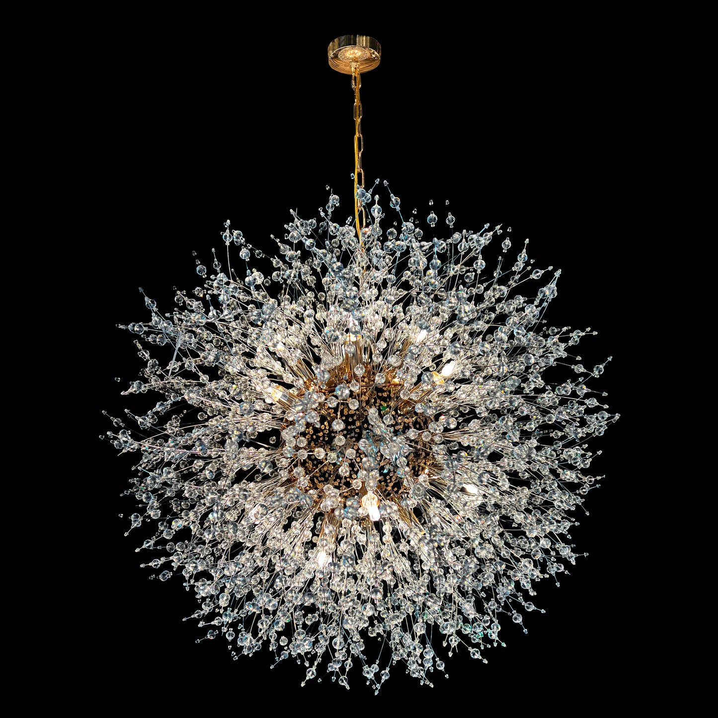 A 24-inch gold crystal chandelier with a starburst design, featuring nano-cut crystal beads and a central gold fixture, hanging from a gold chain.