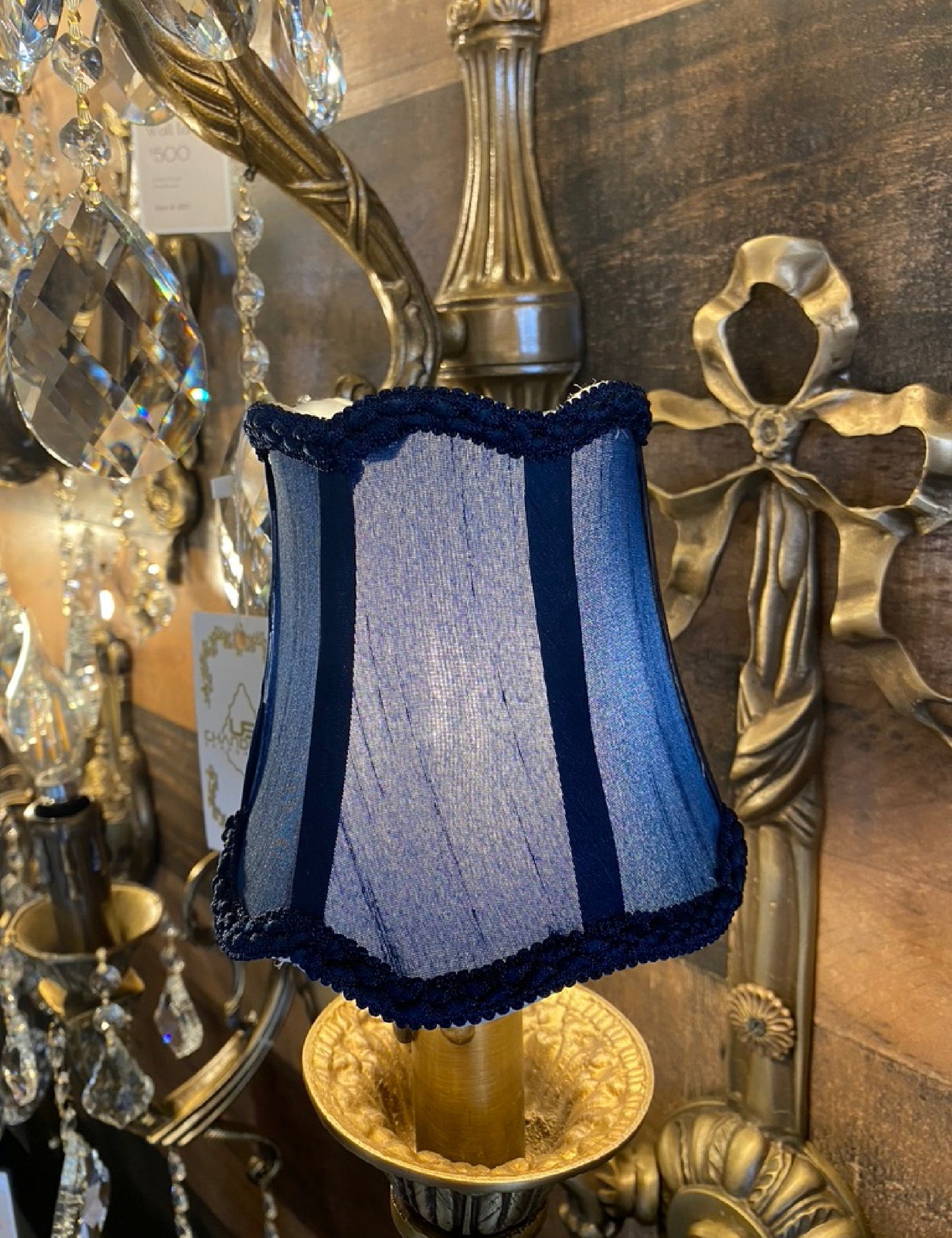 Clip-on navy blue fabric lamp shade on classic chandelier
