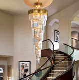 Modern luxury interior with gold spiral crystal chandelier.